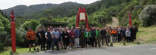 People in front of the new waharoa installed at the start of the Orongorongo Track, Remutaka Forest Park.